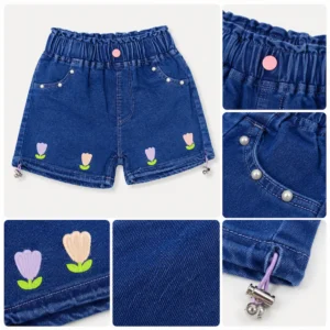 Detalle de shorts de mezclilla para niña con bordado de flores, cintura elástica y acabado de calidad